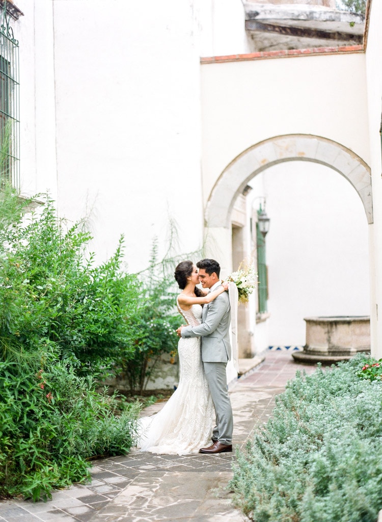 Bridal couple smiling and embracing at hacienda