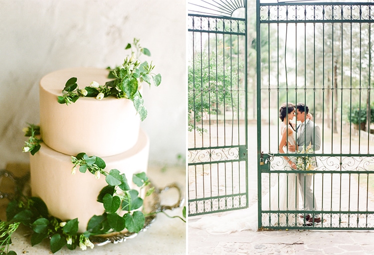 Close up shot of classic white wedding cake with greenery and wedding couple outside gate