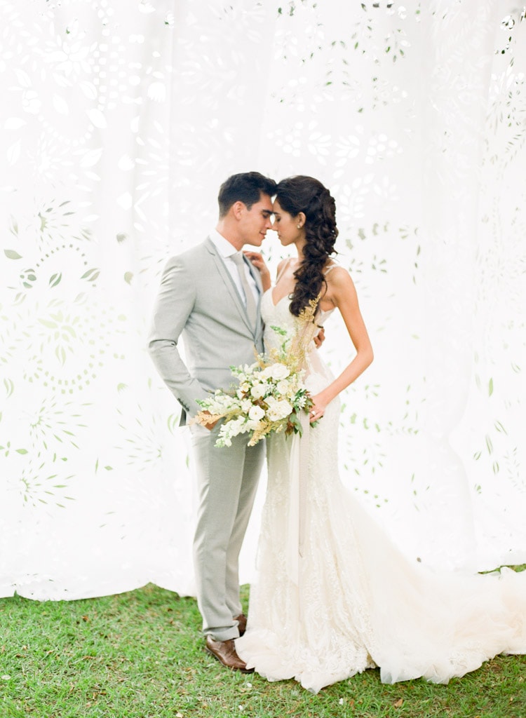 Wedding portrait of couple with white paper backdrop