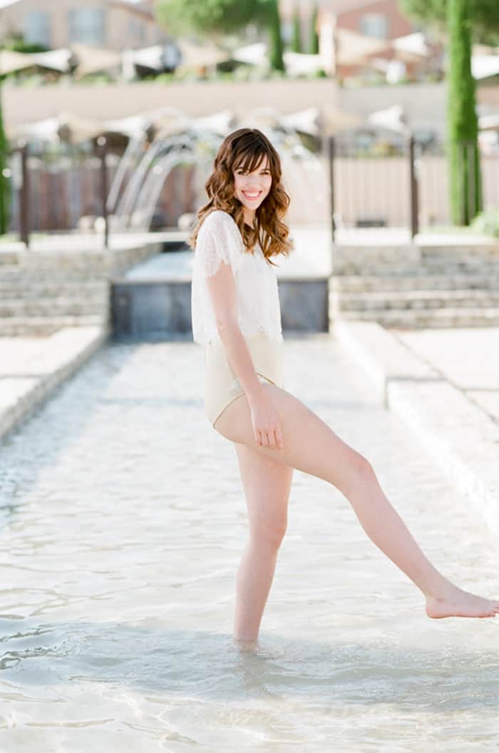 Engaged Bride Playing With Water At Poolside At La Coquillade