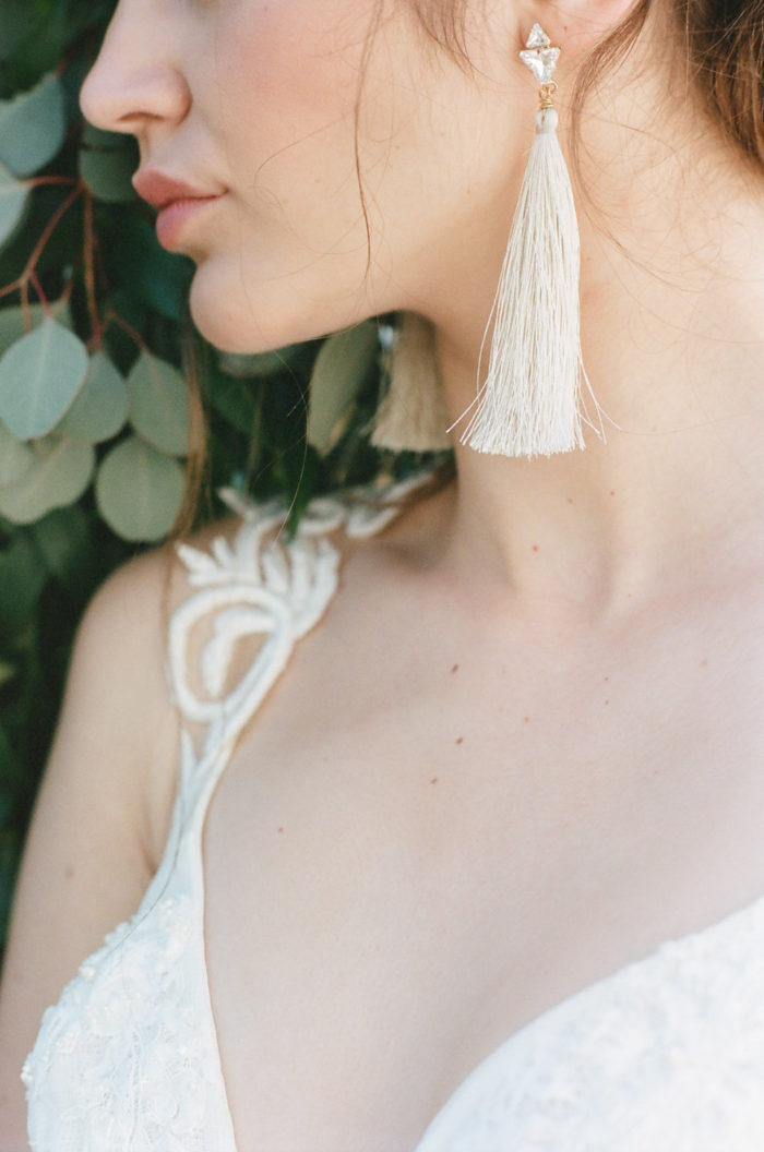 Portrait of a bride wearing long earrings at a wedding in Provence