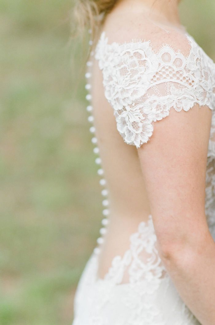 Ines Di Santo wedding gown with an illusion back and trailing buttons at Eaton Ranch in Colorado