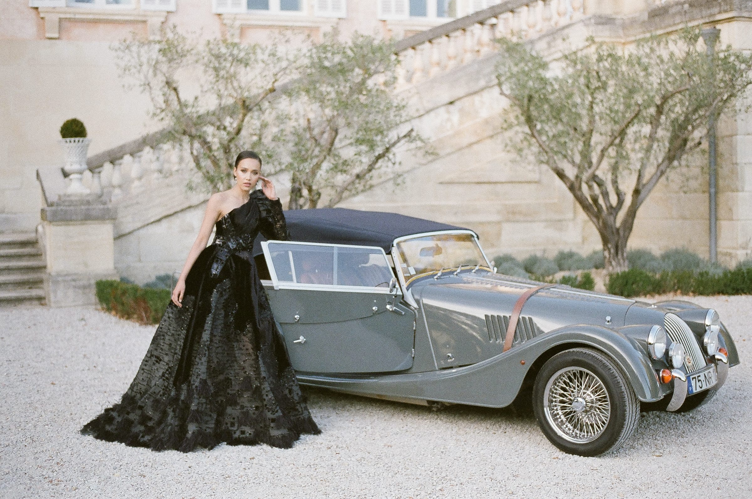 Bride in her black Ziad Nakad haute couture gown standing in front of her Rolls Royce at Chateau Martinay in Provence