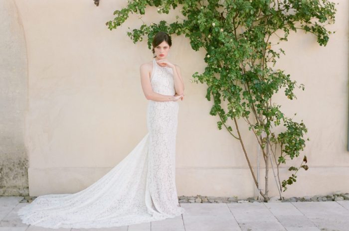 Bride standing in front of an ivy covered wall in Provence