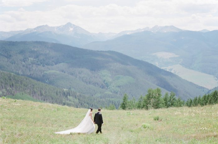 Bride and groom on Vail mountain top with mountain views