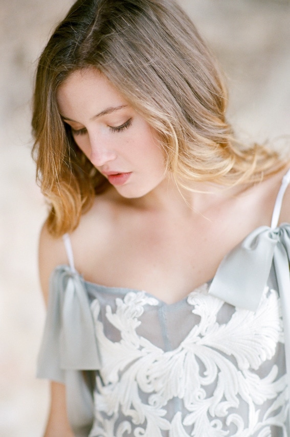 Bride wearing sophisticated French grey lingerie during elegant boudoir portrait session in Colorado