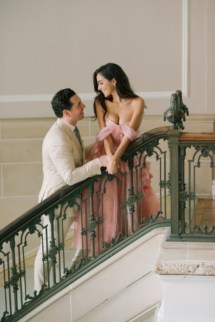 Bride and Groom laughing at each other on stairs at Armour House in Lake Forest