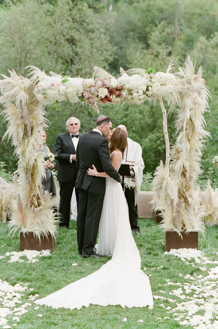 First kiss after wedding ceremony at The Riverfront Westin Resort and Spa in Beaver Creek