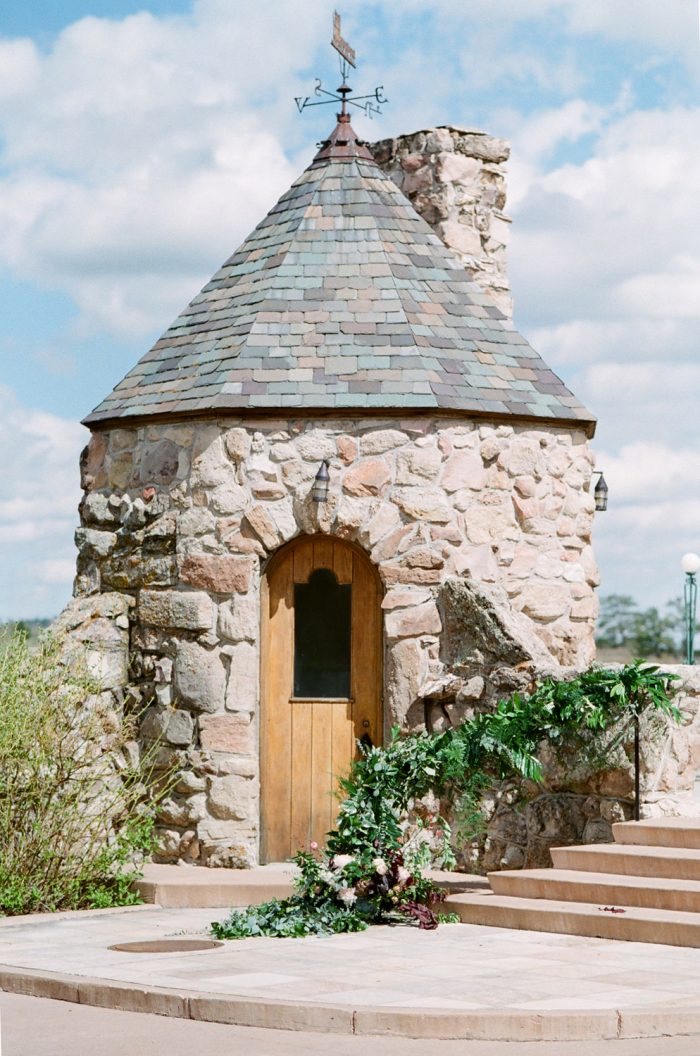 Staircase covered in greenery for a Cherokee Ranch and Castle wedding ceremony