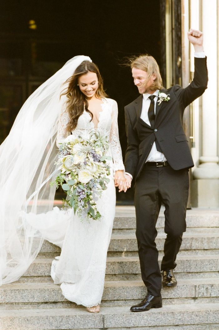Excited bride and groom walking down the stairs after their wedding ceremony in Chicago
