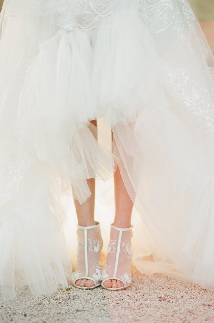 Bride wearing a tulle wedding dress and high heels for a wedding in France