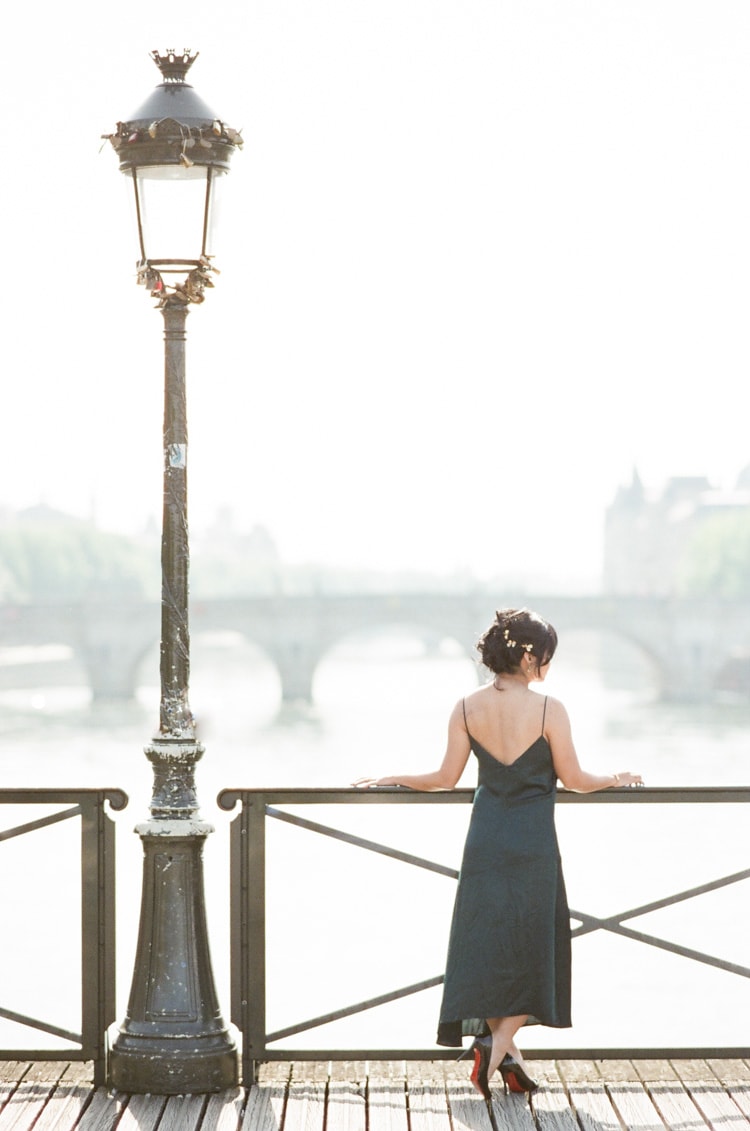 Bride-to-be overlooking the Seine river from a bridge