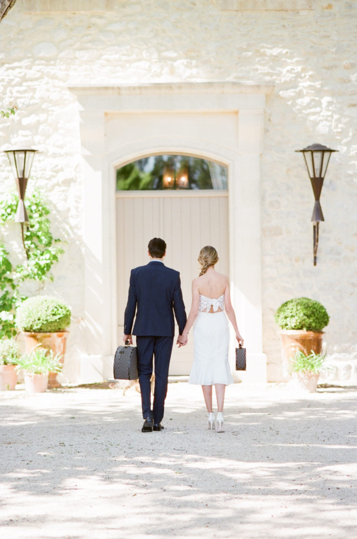 Newlywed couple holding hands while on their honeymoon in Provence