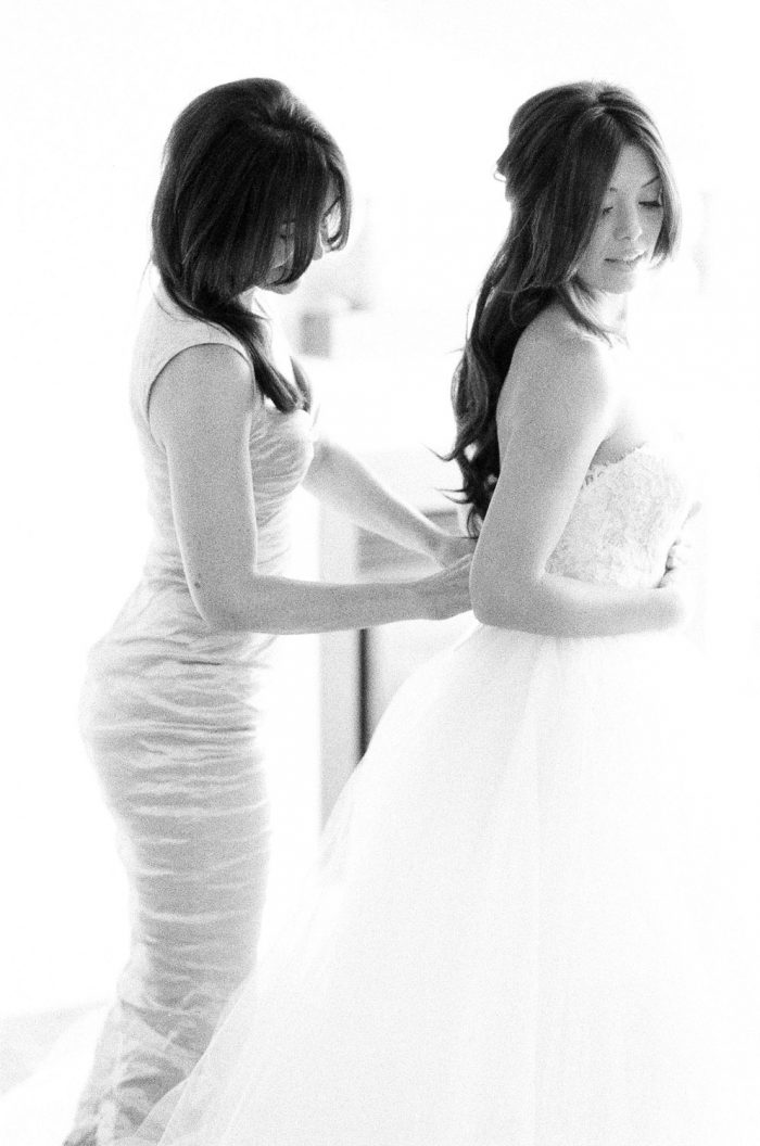 Telluride bride putting on her Hayley Paige wedding dress