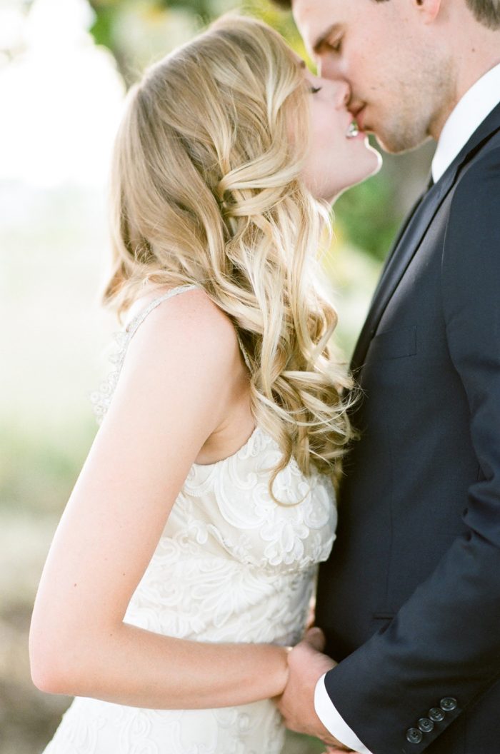 Bride and groom share a kiss at their wedding ceremony in Vail Colorado