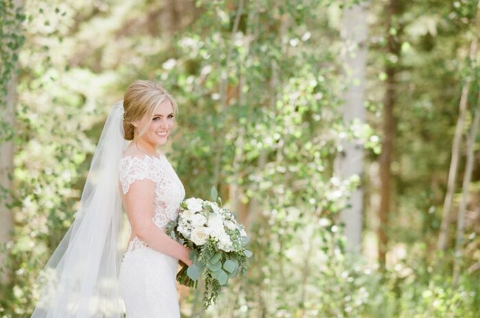 Bride holding white bouquet at Eaton Ranch wedding in Vail
