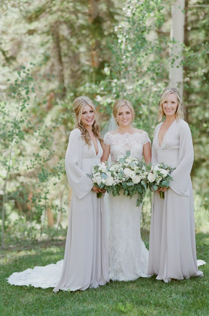 Bride and bridesmaids holding white bouquets at Eaton Ranch wedding in Vail