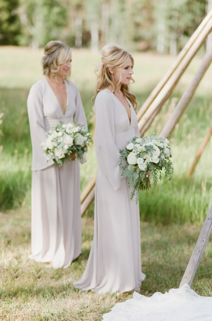 Bridesmaids hold white bouquets at an outdoor wedding ceremony at Eaton Ranch in Vail