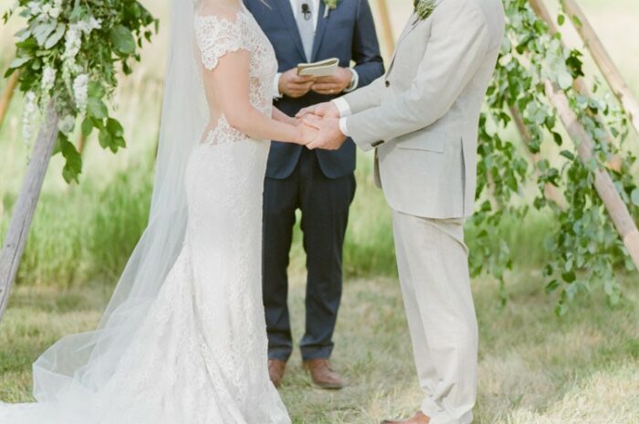 Couple holds hands during their Vail wedding ceremony