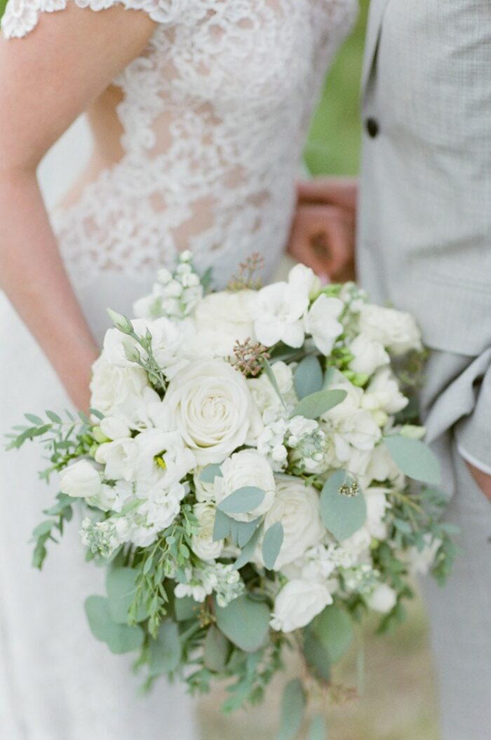 Bride holding white bouquet at Eaton Ranch wedding in Vail