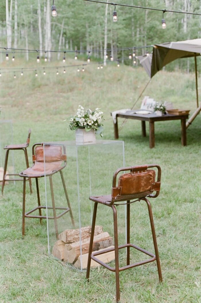 Leather high top chairs at an outdoor wedding reception in Vail Colorado