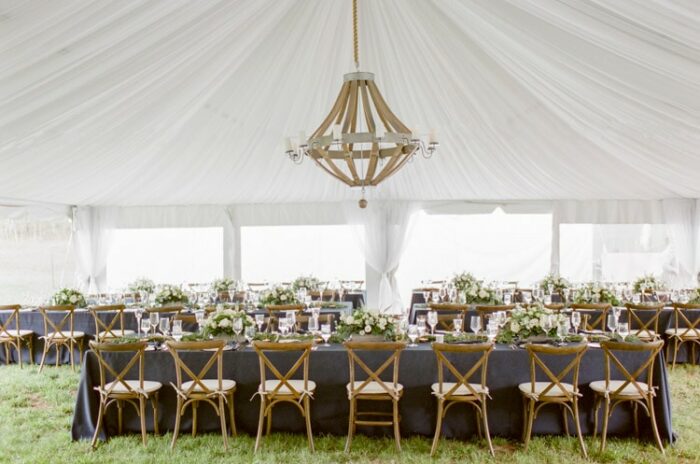 Tented reception at Eaton Ranch in Vail featuring a beautiful oversized chandelier