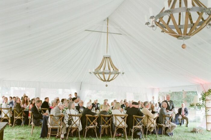 Tented reception at Eaton Ranch in Vail featuring a beautiful oversized chandelier