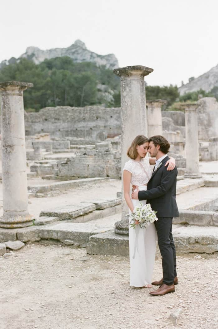 Bride wearing a two piece outfit at Glanum Ruins in Provence