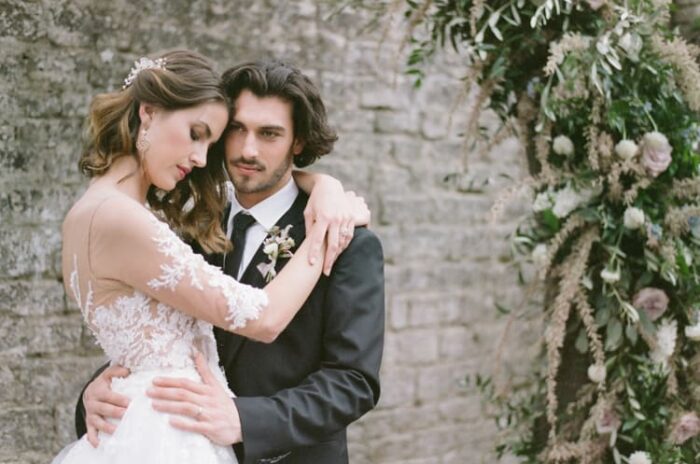 Bride and groom embracing each other at the ruins of Glanum