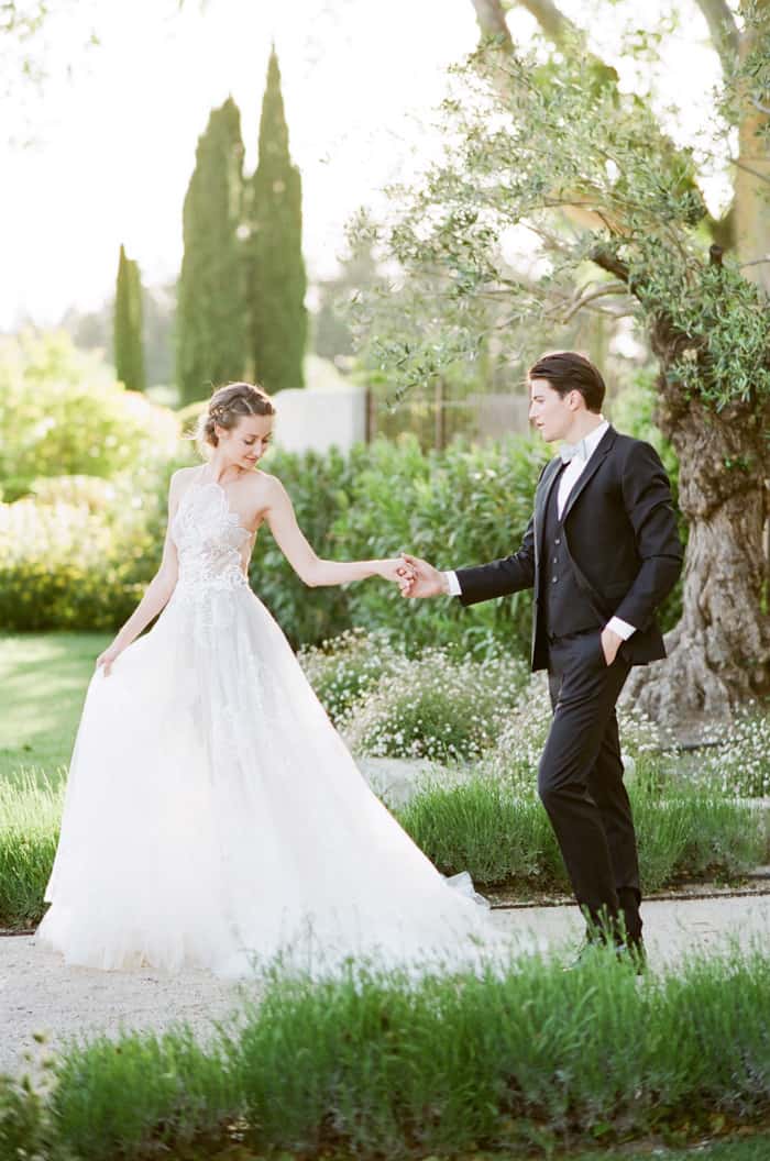 Wedding Couple Walking together holding hands at private estate Le Clos Saint Esteve for wedding portraits
