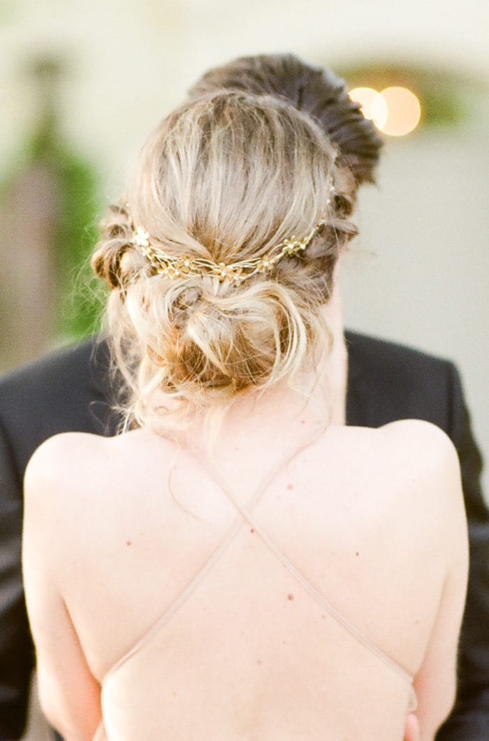 Bride facing away revealing behind view of wedding gown
