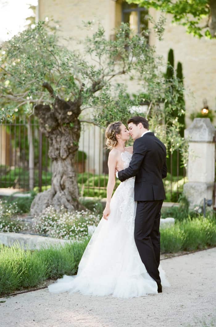 Happy Wedding Couple Kissing in front of olive tree
