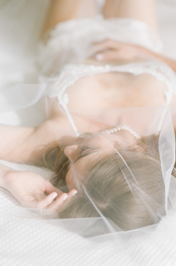 Bride wearing veil at her bridal boudoir session in Colorado