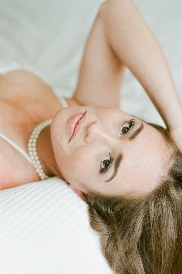 Bride looking into the camera during her boudoir session