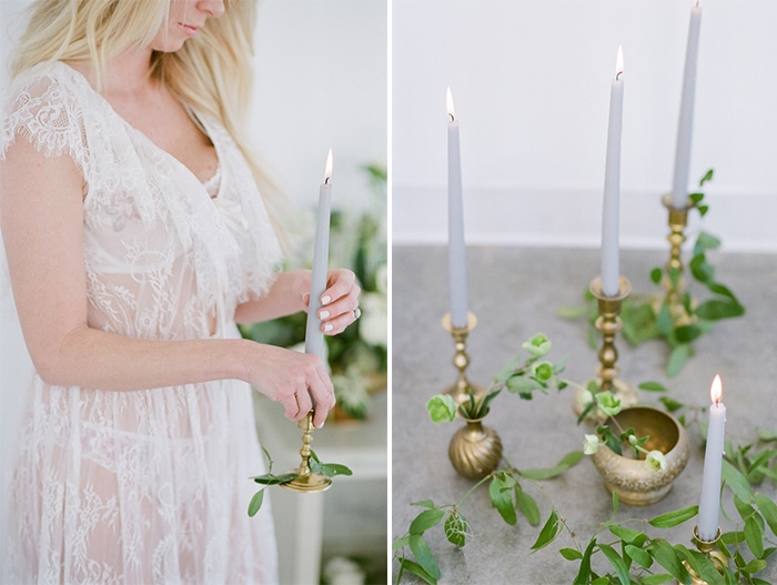 Bride in her white lace morning gown holding a candle