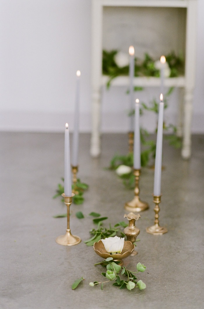 Closeup of gold candle holders and blue candles
