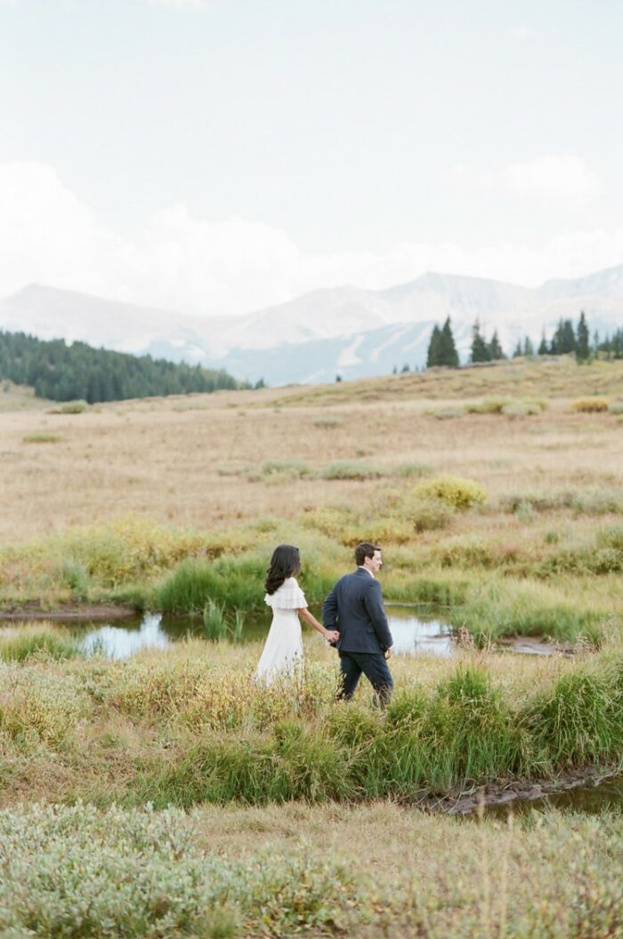 Far out rustic portrait shot of couple walking away