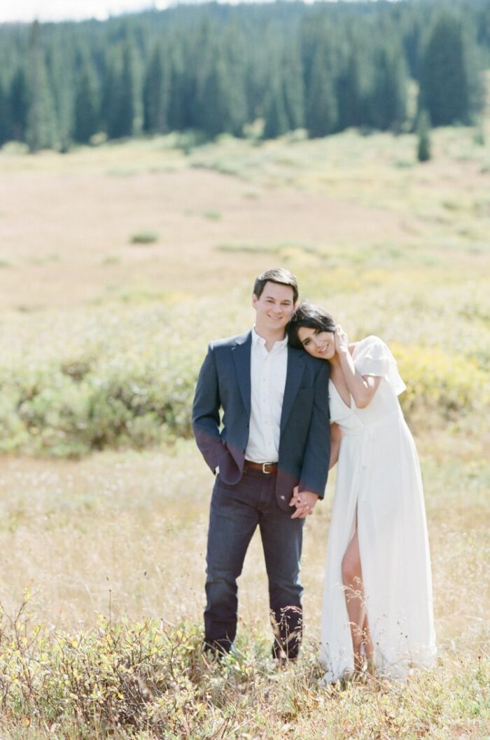 Engaged couple with formal outfits with woman wearing a white gown and man donning jeans and sport jacket