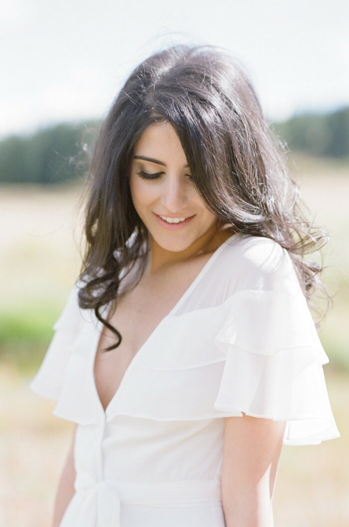 Engagement portrait session of woman in romantic white gown