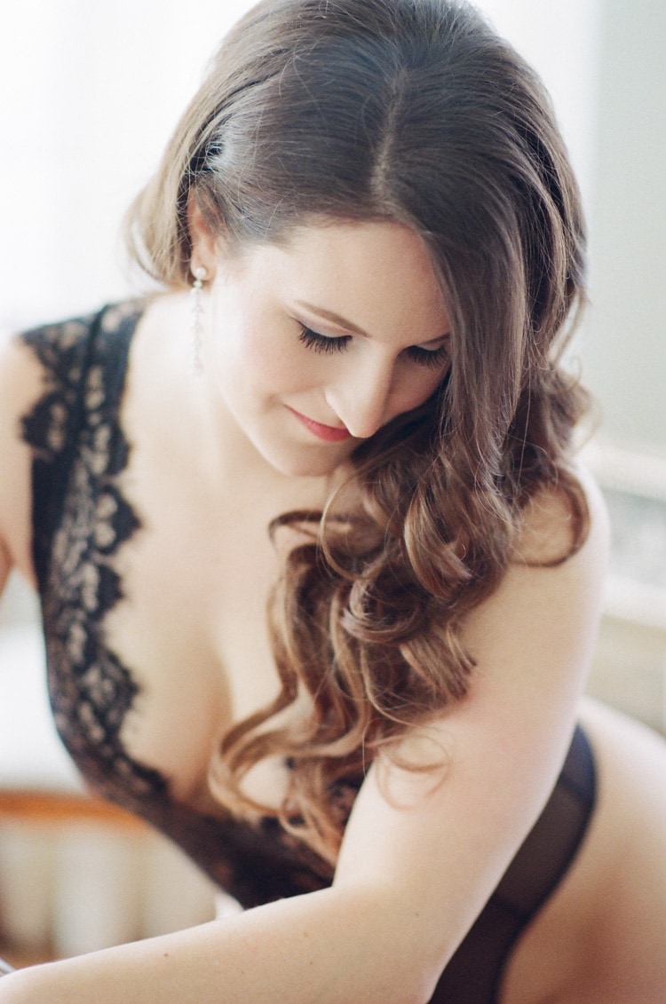 Elegant black lace lingerie worn during a boudoir portrait session