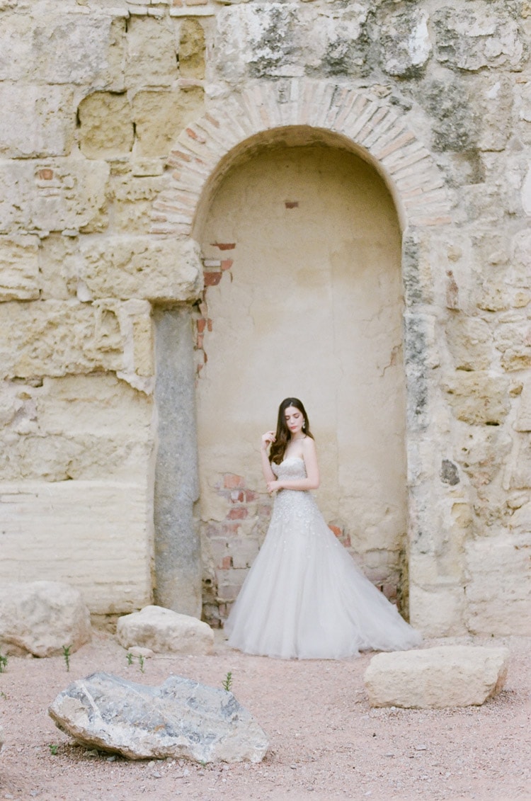 Bride in front of old stone building in Cordoba Spain
