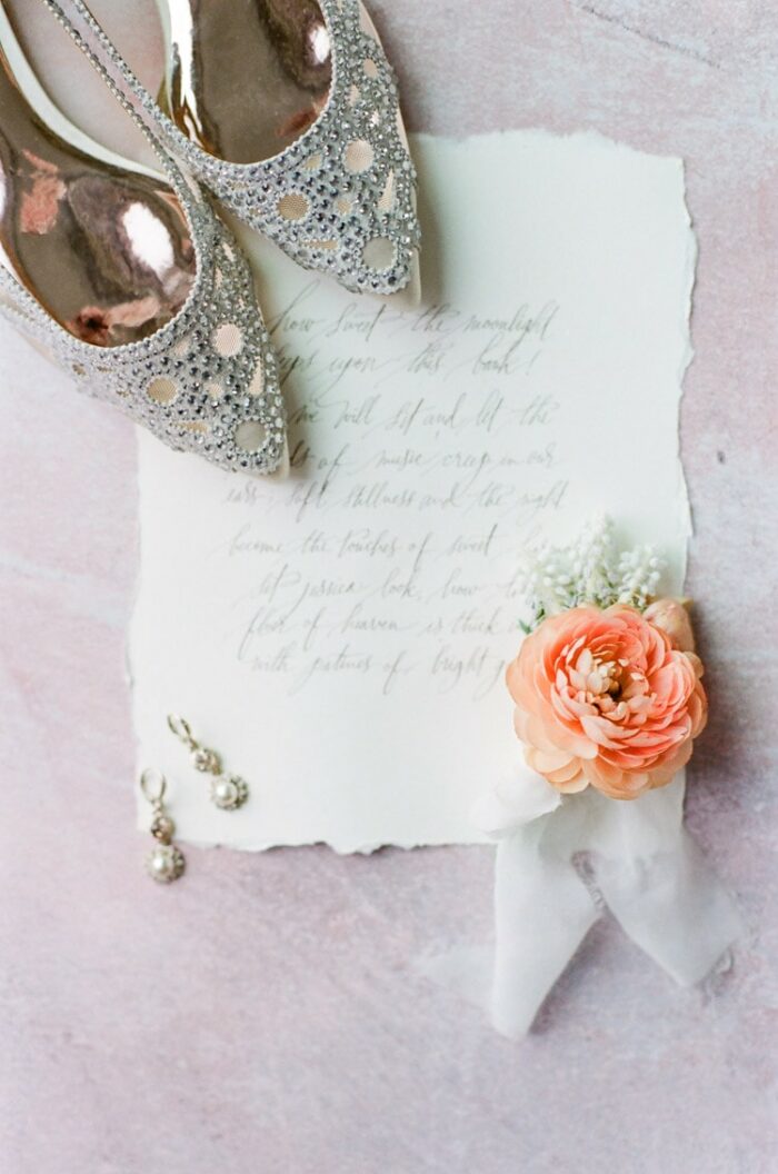 Silver shoes and a coral flower on a love note