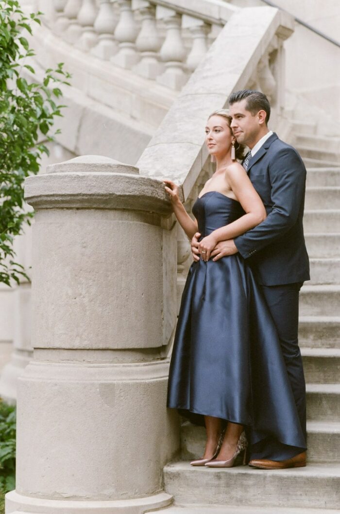 Couple standing on exterior staircase