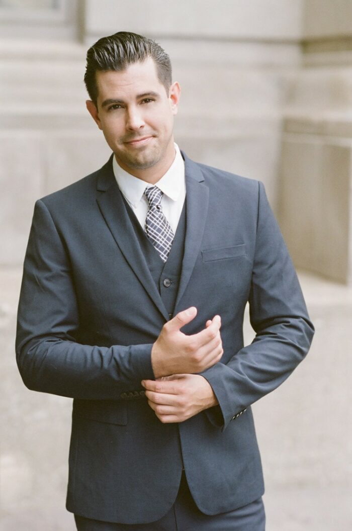 Portrait of man in navy blue suit