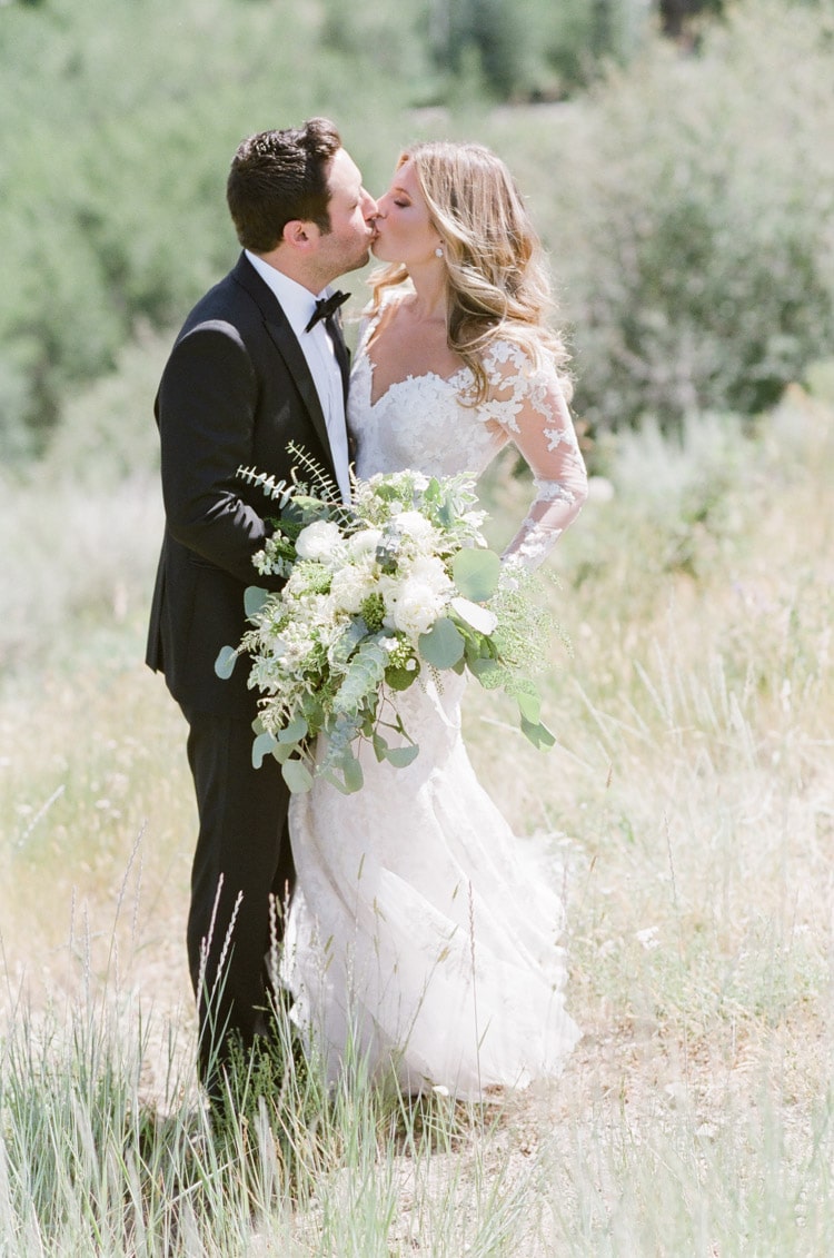Wedding portrait session of couple kissing
