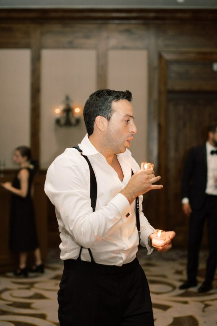 Groom holding candles at reception