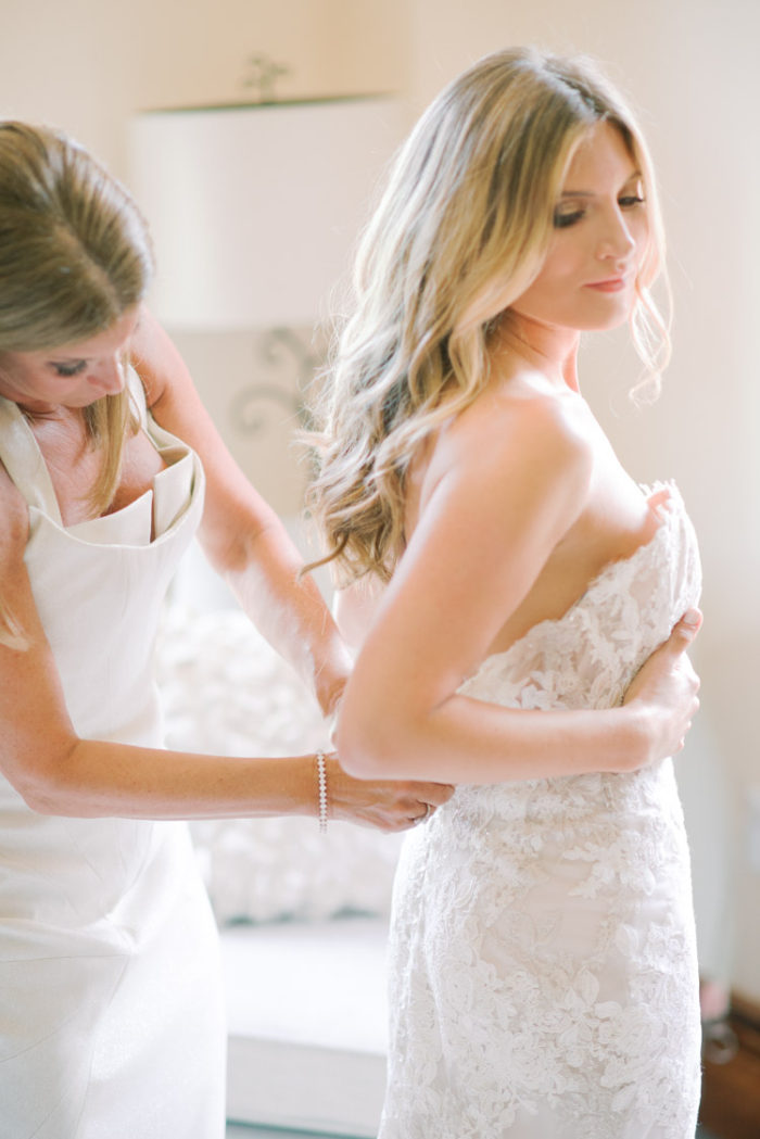 Bride getting ready with bridesmaid