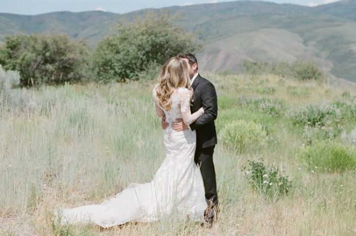 Couple embracing each other in grass fields