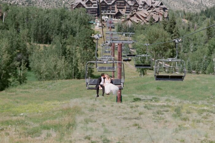 Wedding couple riding the gondola with the Ritz-Carlton resort in the background