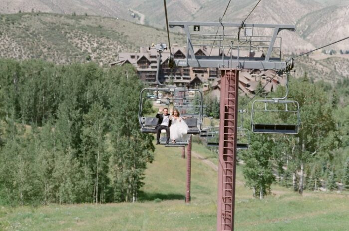 Wedding couple riding the gondola up the mountain